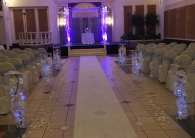 Signature Grand Acrylic Chuppah Rental With Purple Uplights and Silk Orchids